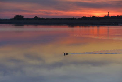 Scenic view of lake against sky during sunset