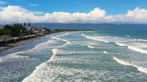 The coast with hotels and tourists, a famous place for surfing. 