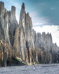 Panoramic shot of rocks by sea against sky