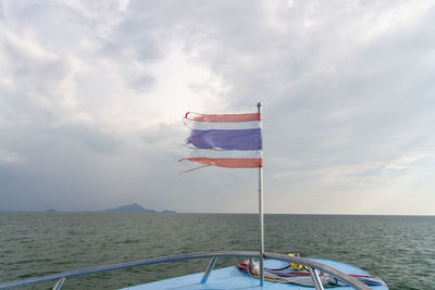 Sailboat sailing on sea against sky