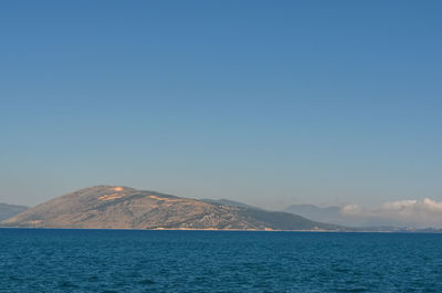 Scenic view of sea against clear blue sky