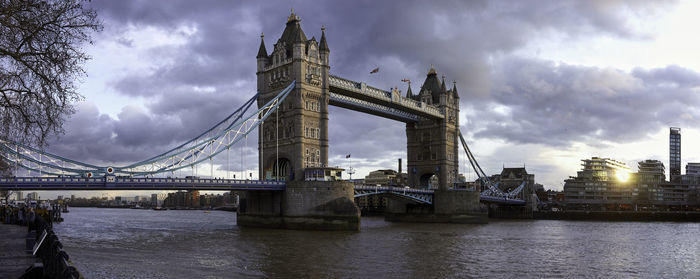 View of bridge over river against cloudy sky