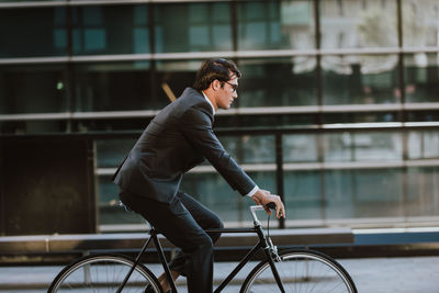 Side view of man riding bicycle