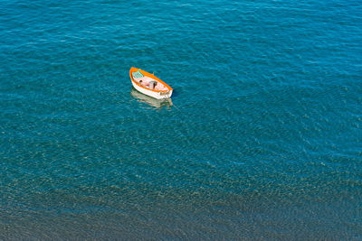 High angle view of boat anchored on sea