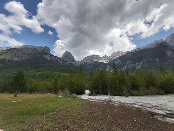 Scenic view of mountains against cloudy sky