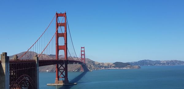 View of suspension bridge against clear sky