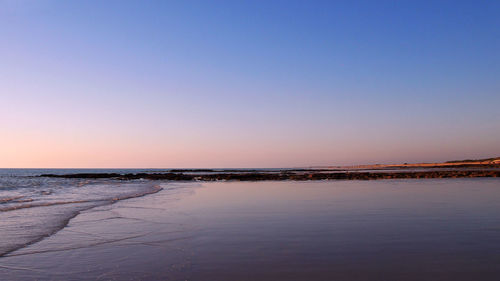 Scenic view of sea against clear blue sky