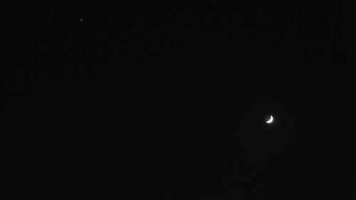 Low angle view of moon against sky at night