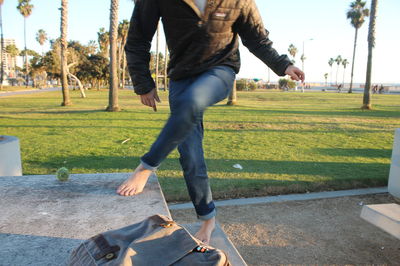 Low section of woman standing on grass