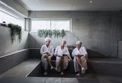 Senior women reading magazines