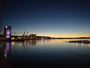 View of city at waterfront at night