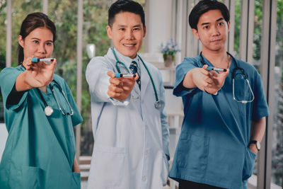 Doctors holding test tubes at hospital