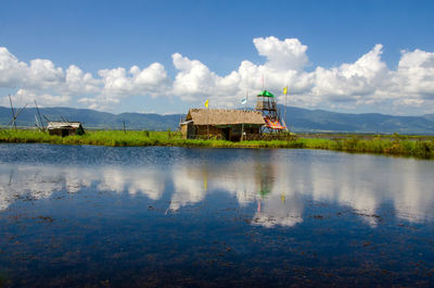 Scenic view of lake by building against sky