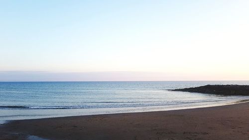 Scenic view of sea against clear sky during sunset