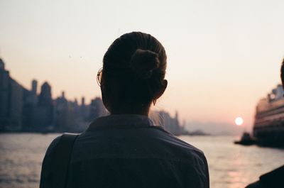 Rear view of woman looking at sunset
