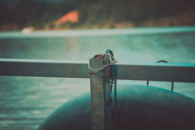 Close-up of life belt hanging on railing 