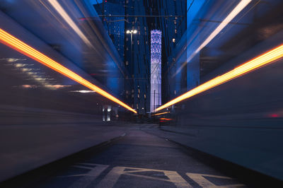 Light trails on bridge in city at night