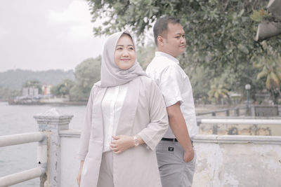 Portrait of young couple standing outdoors