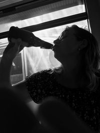 Silhouette woman drinking while sitting