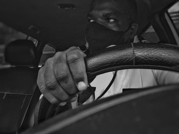 Portrait of man holding smart phone in car