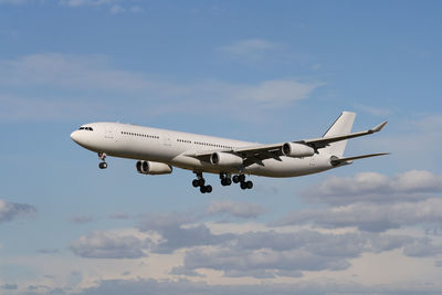 Low angle view of airplane flying in sky