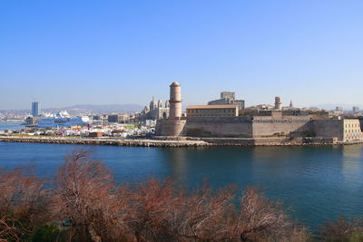 View of buildings in city against clear sky