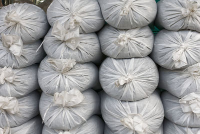 Full frame shot of stacked white sacks