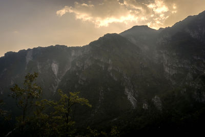 Scenic view of mountains against sky at sunset