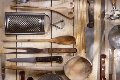 Various kitchen utensils hanging on wood