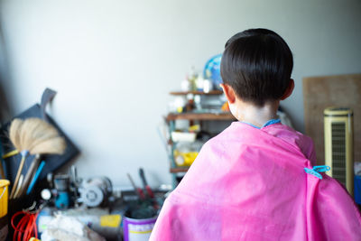 Rear view of boy standing at home