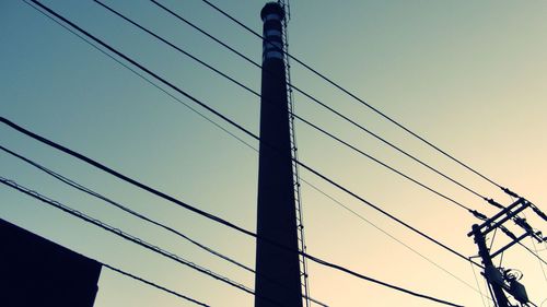 Low angle view of suspension bridge against sky