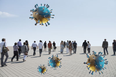 Group of people flying against clear sky