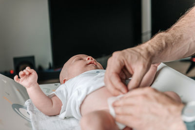 Dad changing baby's diapers