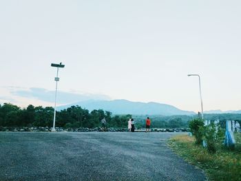 Man walking on road against clear sky