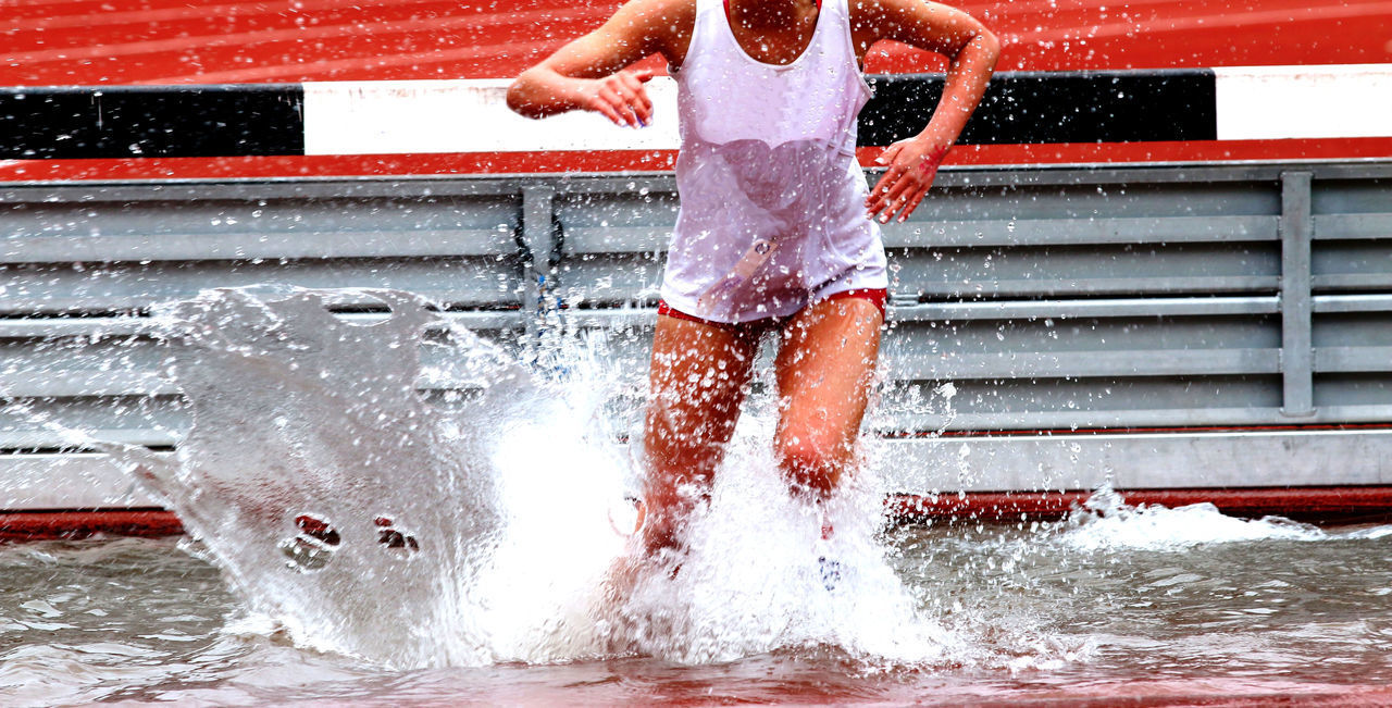 LOW SECTION OF PERSON STANDING IN SWIMMING POOL