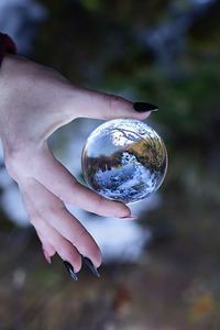 Close-up of woman hand holding crystal ball