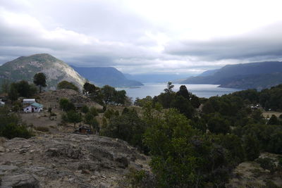 Scenic view of landscape by sea against sky