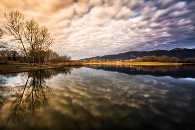 Scenic view of lake against sky during sunset