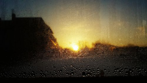 Sunset seen through wet window