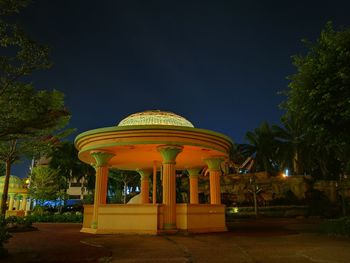 Illuminated building against sky at night