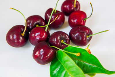 Close-up of cherries over white background