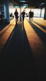 Silhouette people walking in corridor