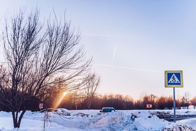 Snow covered road against sky during winter