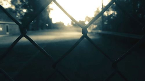 Close-up of chainlink fence against sky