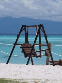 Lifeguard hut on beach against sky