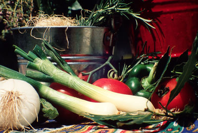 Close-up of vegetables with container on table