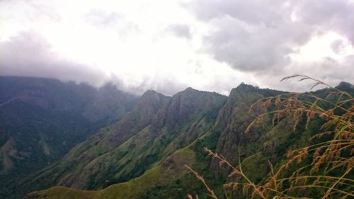 Scenic view of mountains against cloudy sky