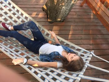 High angle view of woman relaxing on hammock