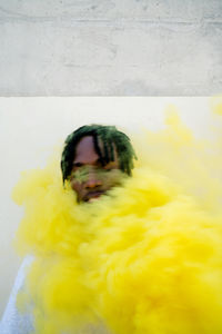 Young black man with a yellow smoke