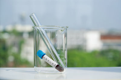 Close-up of glass container with reflection on green background